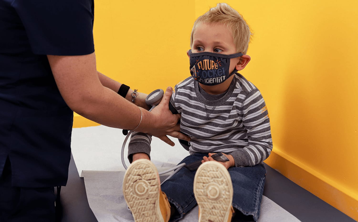 A young boy has his blood pressure measured